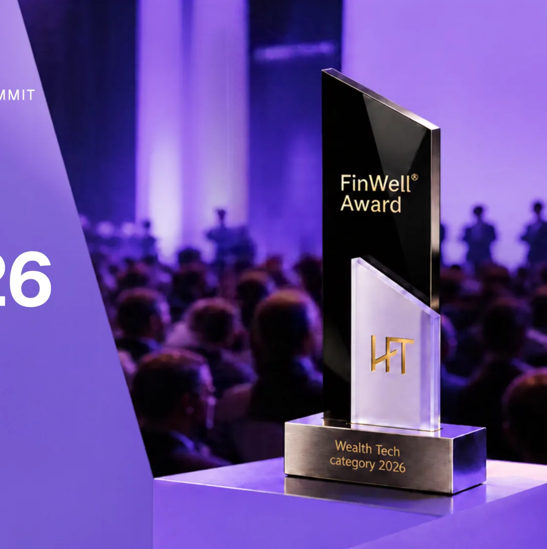 The FinWell Award trophy on a lit stage in front of the Summit audience: an angled black glass panel with gold FinWell Award lettering, a frosted glass panel with the gold HoFT monogram and a brushed-steel base engraved Wealth Tech category 2026